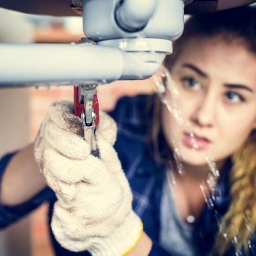 A residential plumber repairs a leak.